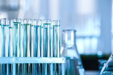 Test tubes with liquid samples for analysis in laboratory, closeup