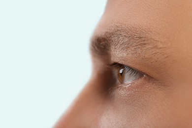 Photo of Closeup view of man with beautiful eye on blurred background. Space for text