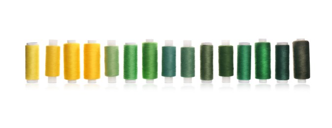 Photo of Set of colorful sewing threads on white background