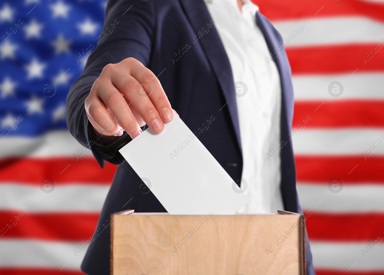 Image of Election in USA. Woman putting her vote into ballot box against national flag of United States, closeup