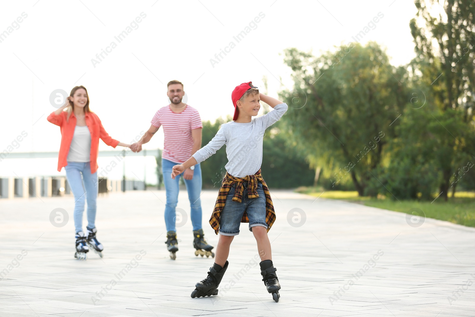 Photo of Happy family roller skating on city street