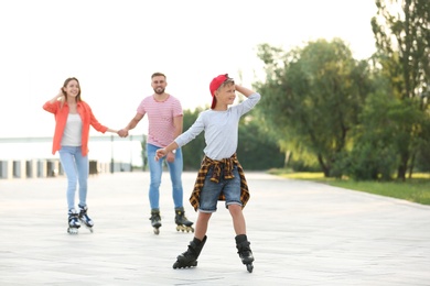 Photo of Happy family roller skating on city street