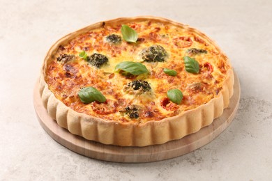 Delicious homemade vegetable quiche on light gray table