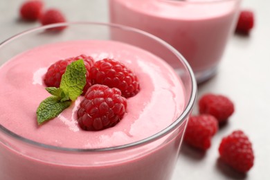 Photo of Delicious raspberry mousse with mint in glass bowl, closeup