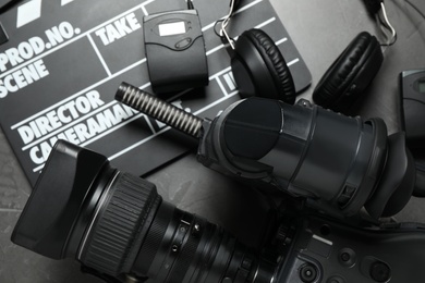 Photo of Camera and video production equipment on grey background, top view