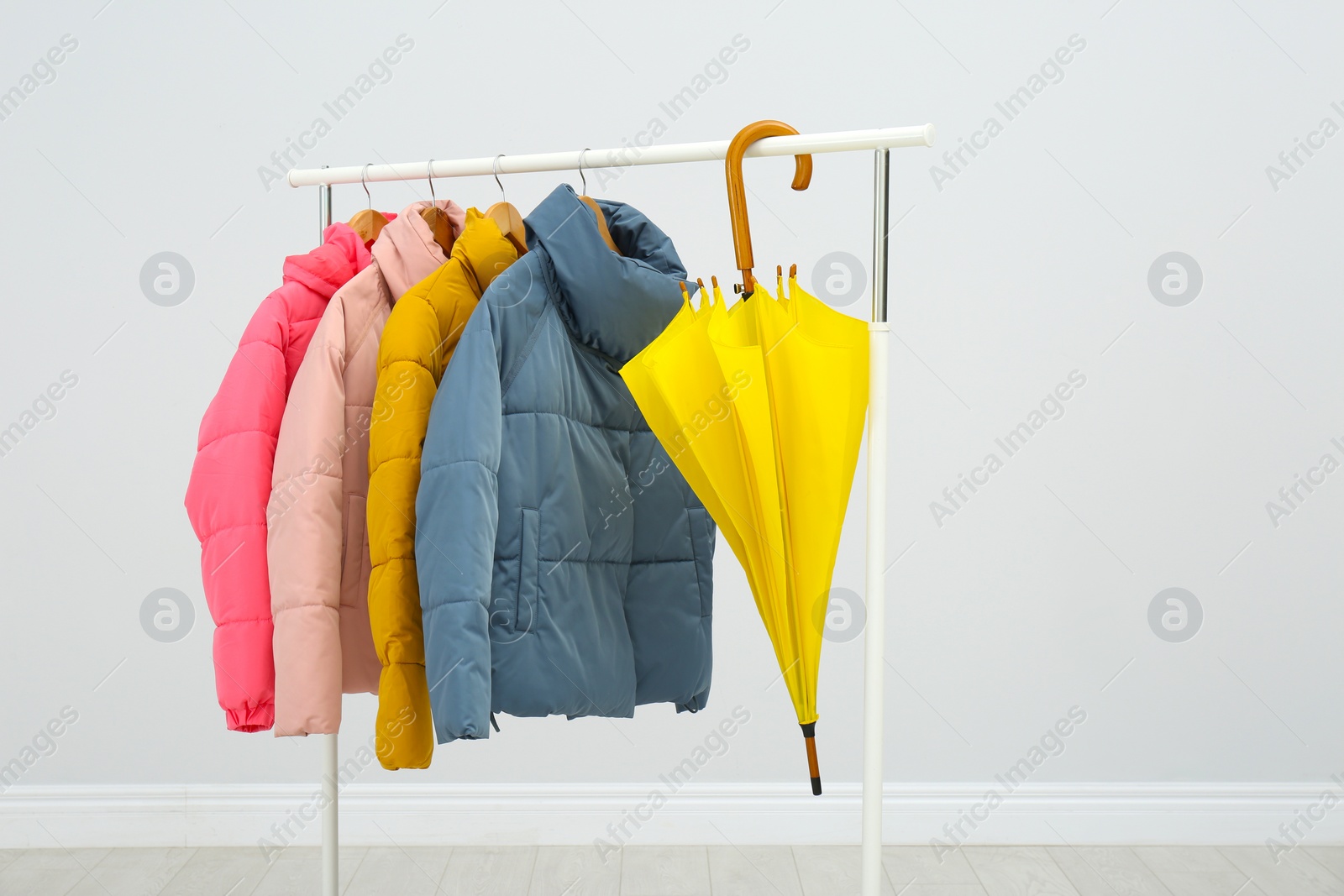 Photo of Rack with bright warm jackets in room