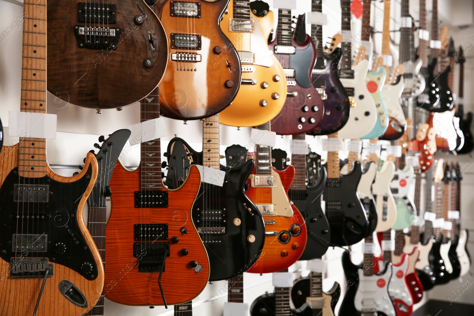 Photo of Rows of different guitars in music store