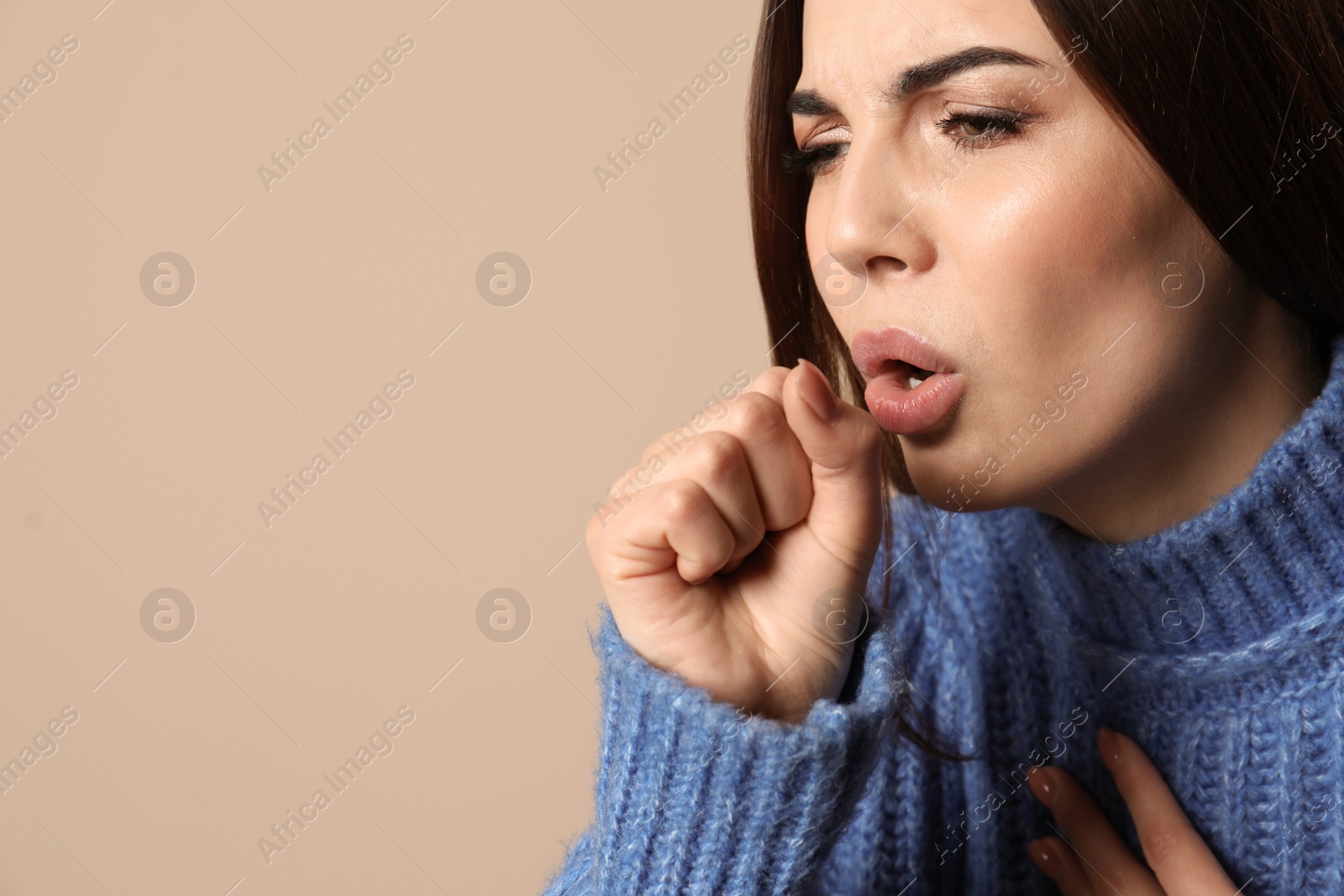 Photo of Beautiful young woman coughing against color background. Space for text