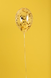Photo of Balloon with sparkles on color background. Space for text