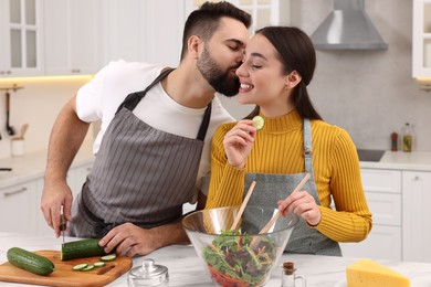 Photo of Lovely young couple cooking together in kitchen