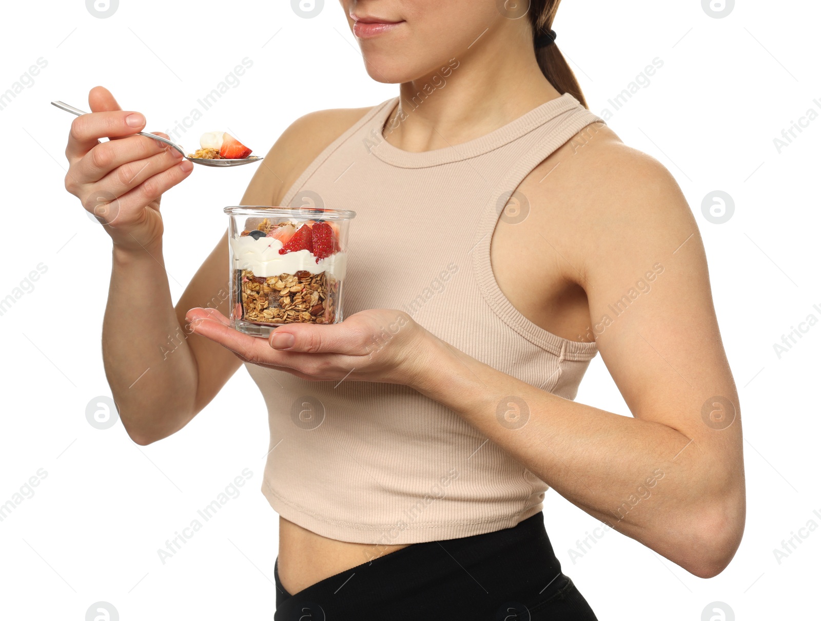 Photo of Woman eating tasty granola with fresh berries and yogurt on white background, closeup