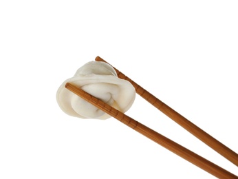 Photo of Chopsticks with tasty dumpling isolated on white