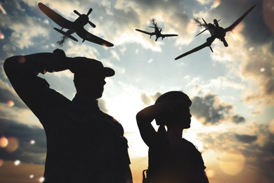 Silhouettes of soldiers saluting and planes in combat zone. Military service