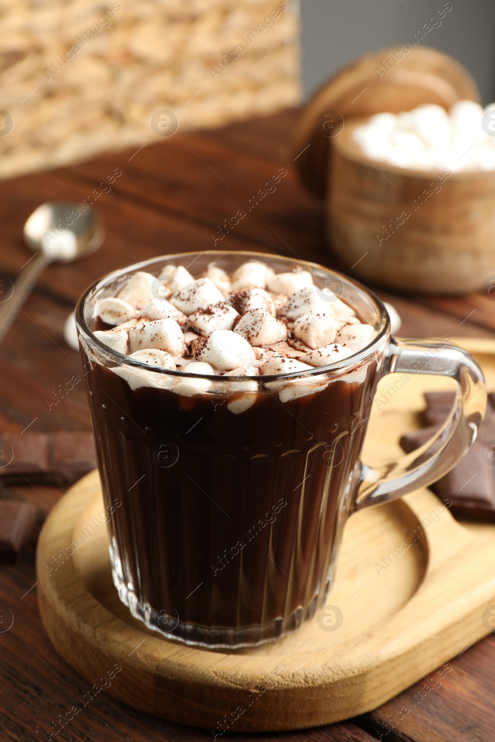 Photo of Cup of aromatic hot chocolate with marshmallows and cocoa powder served on table, closeup