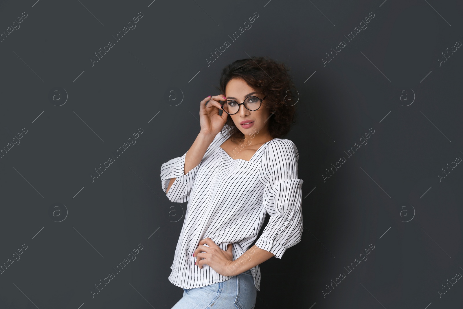 Photo of Beautiful woman wearing glasses on black background