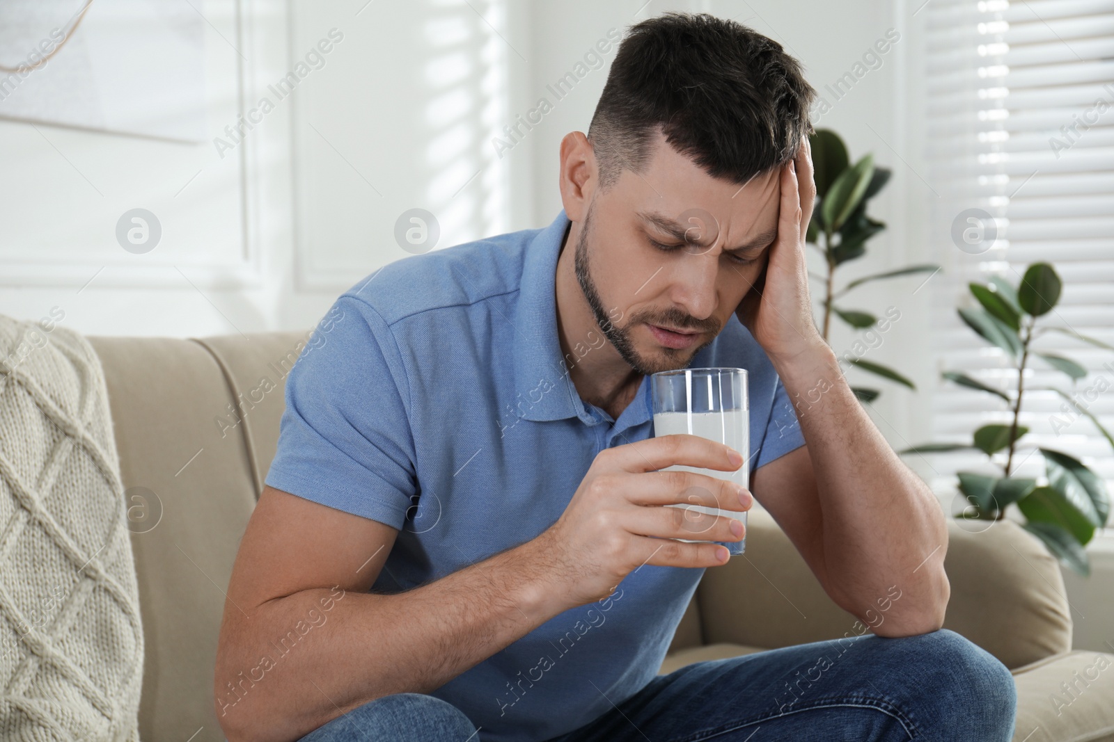 Photo of Man taking medicine for hangover at home