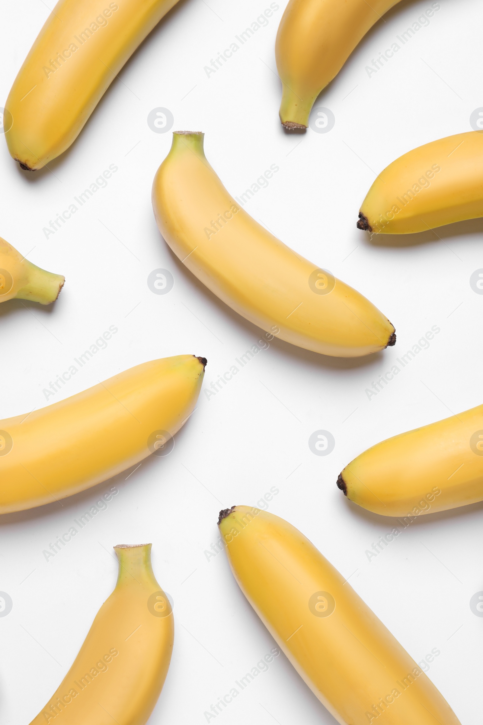 Photo of Sweet ripe baby bananas on white background, top view