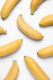 Sweet ripe baby bananas on white background, top view