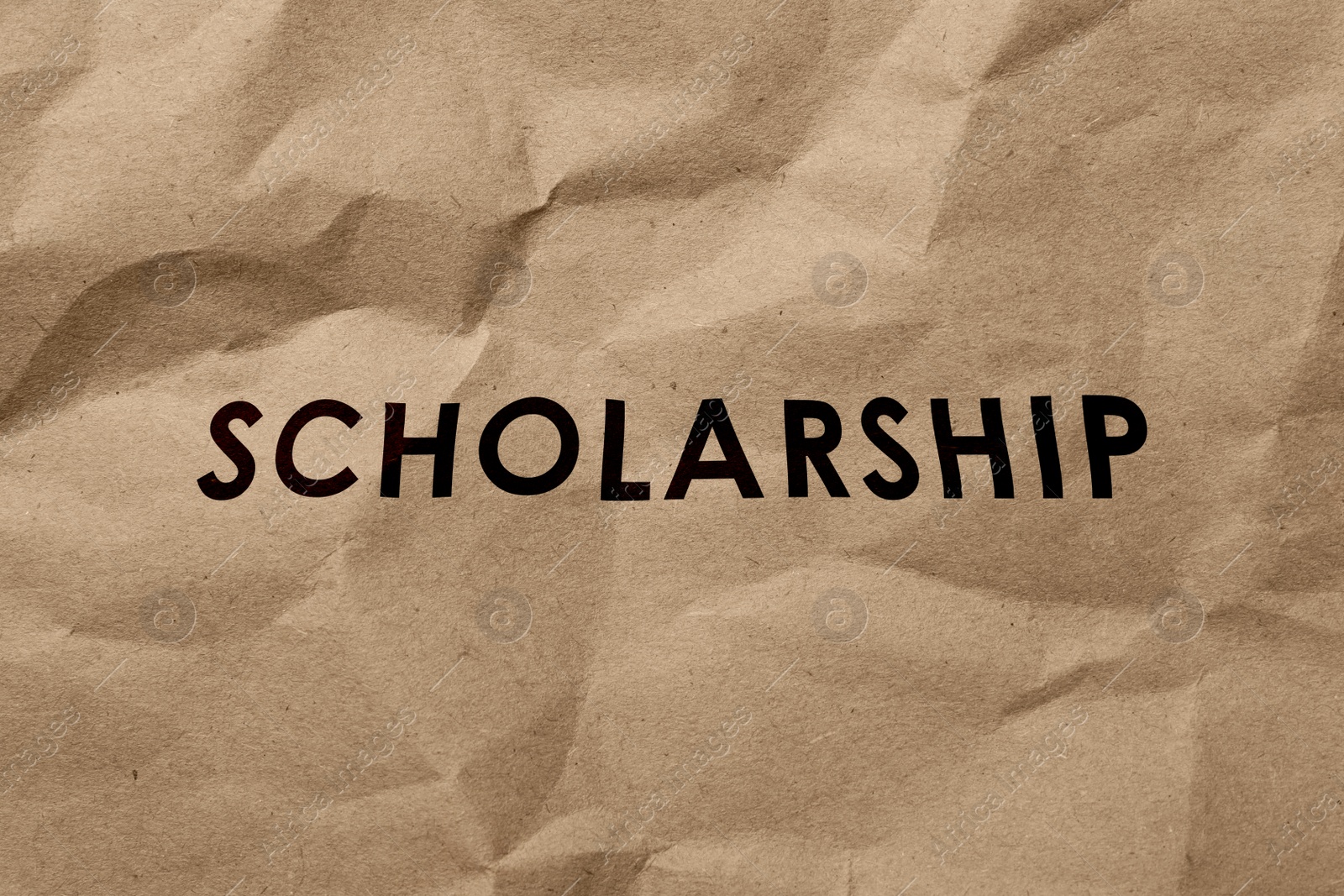 Image of Word SCHOLARSHIP written on crumpled kraft paper