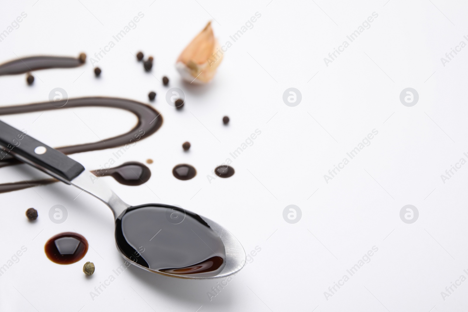 Photo of Organic balsamic vinegar and cooking ingredients on white background. Space for text