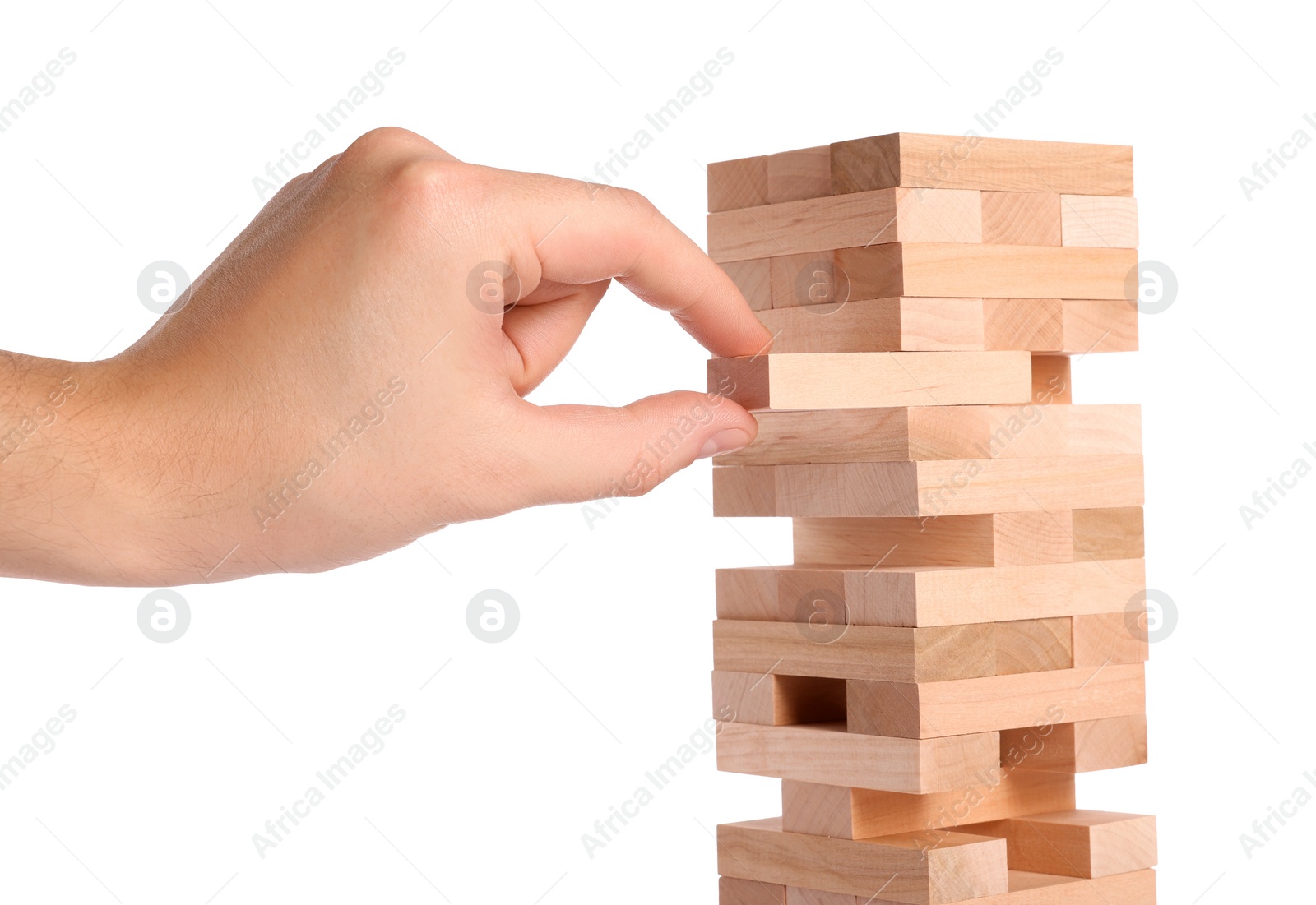 Photo of Playing Jenga. Man removing wooden block from tower on white background, closeup