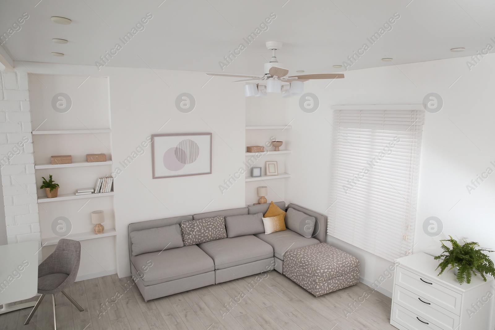 Photo of Ceiling fan, furniture and accessories in stylish living room, above view