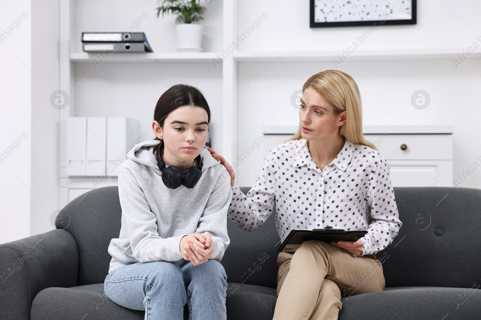 Photo of Psychologist working with teenage girl in office