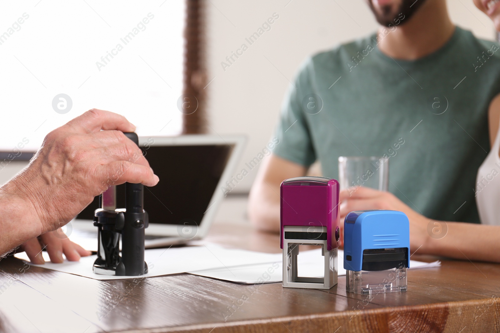 Photo of Senior notary working with clients in office, closeup