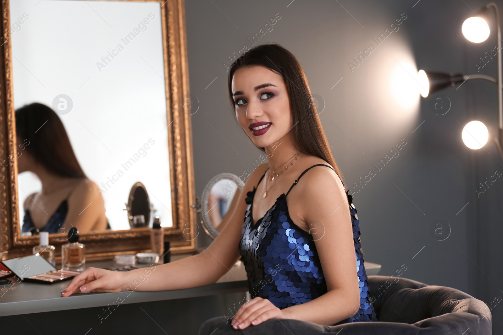 Photo of Portrait of beautiful woman with bright makeup indoors