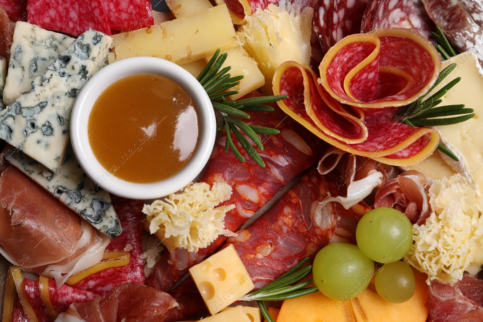 Photo of Different appetizers with dip sauce as background, top view