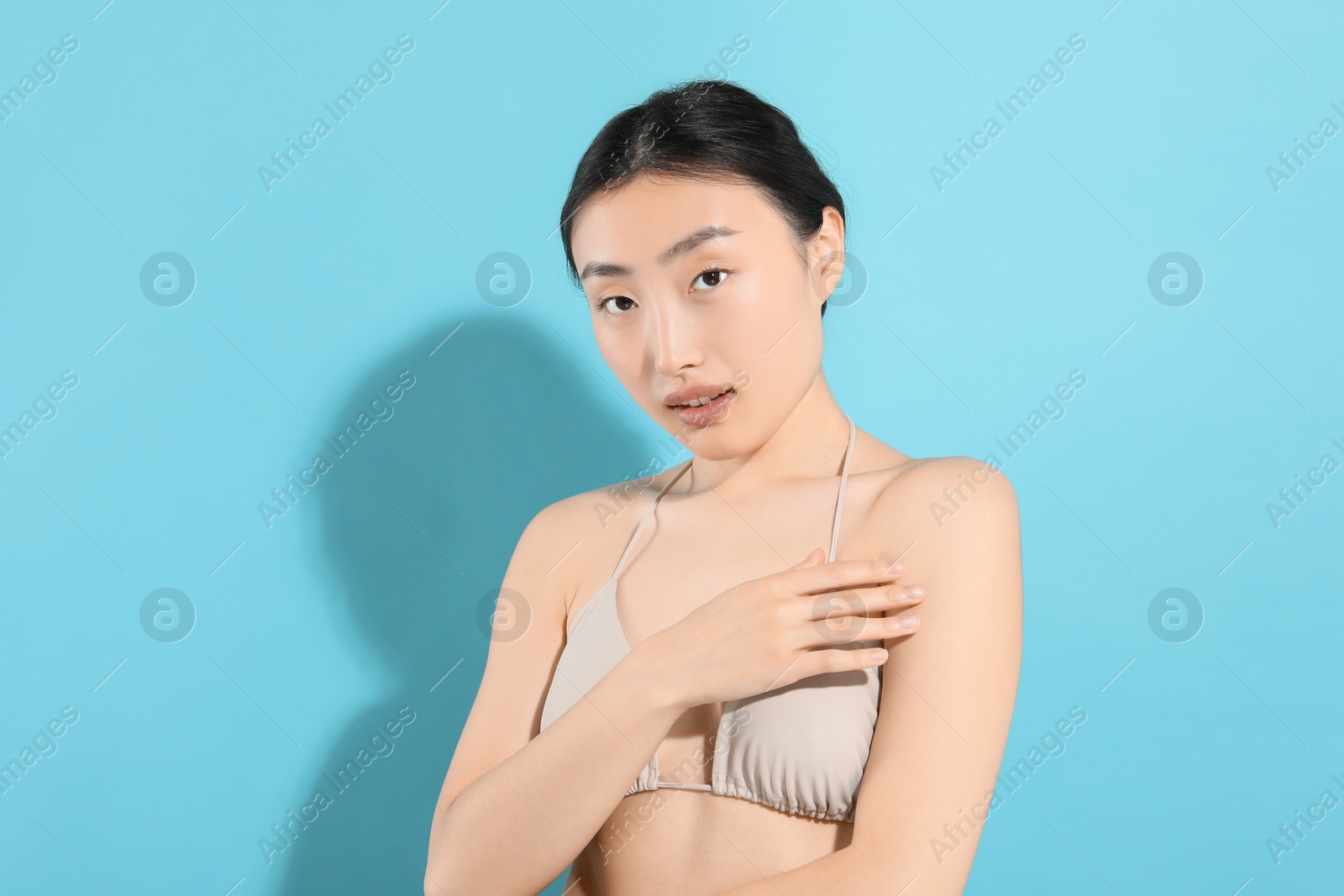 Photo of Beautiful young woman on light blue background