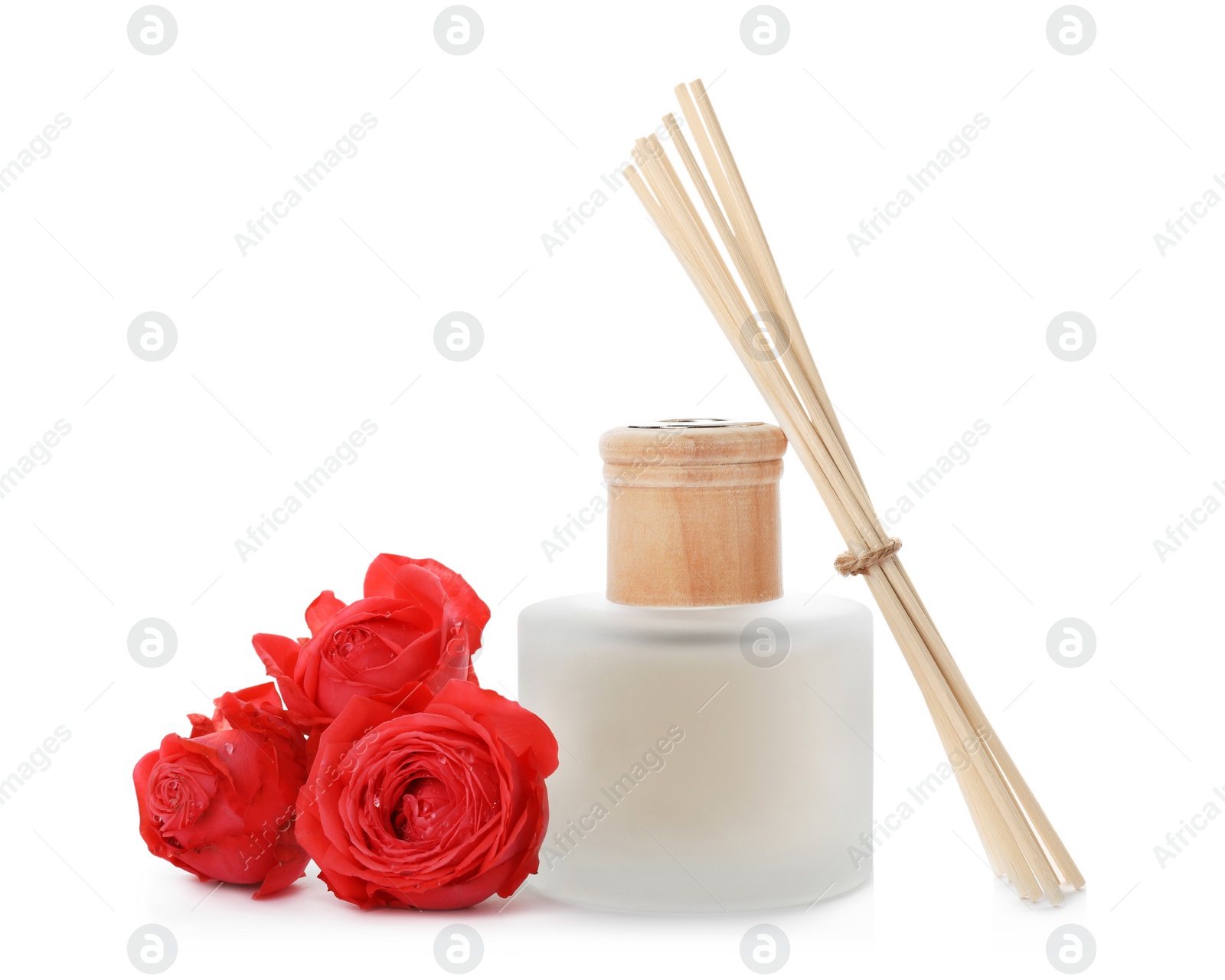 Photo of Aromatic reed freshener and roses on white background