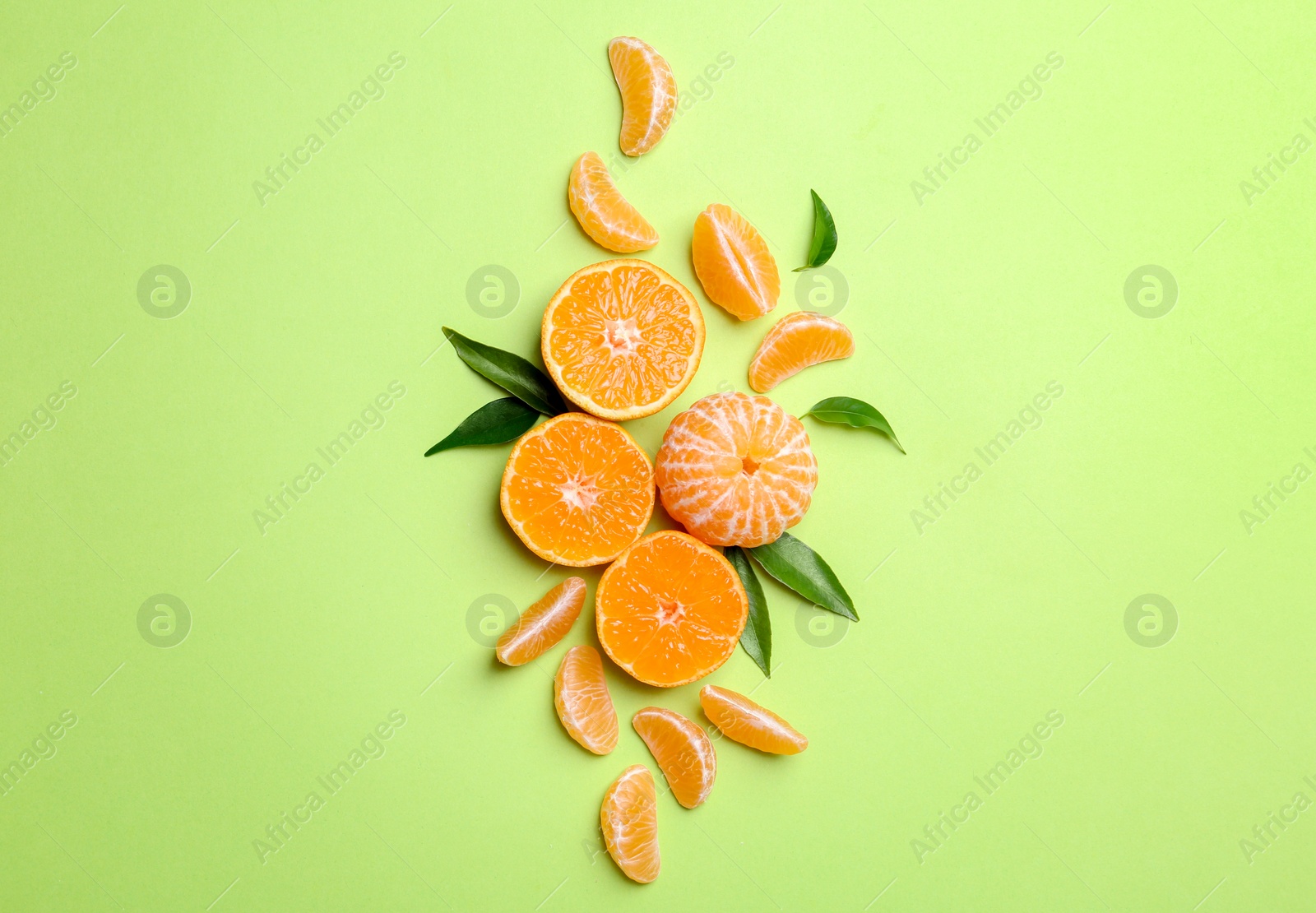 Photo of Composition with tangerines and leaves on color background, flat lay