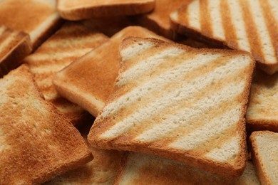 Photo of Slices of tasty toasted bread as background, closeup