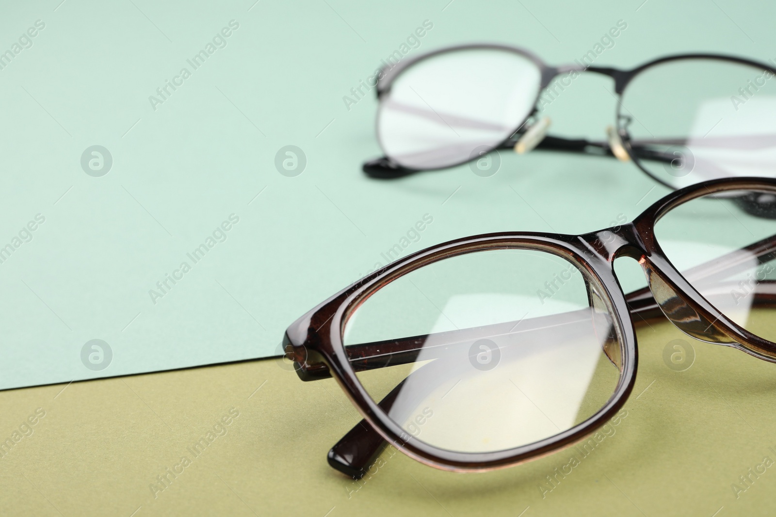 Photo of Glasses on color background, closeup. Space for text