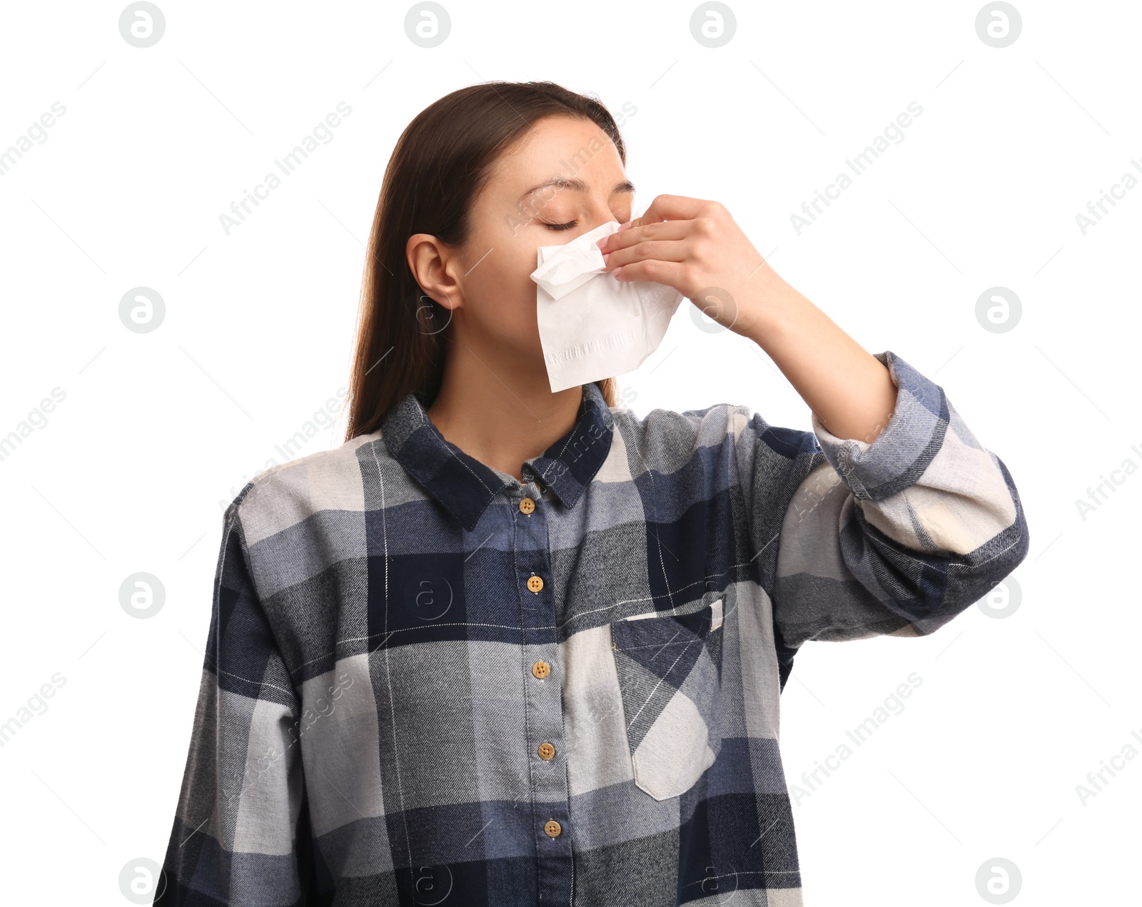 Photo of Young woman with tissue suffering from runny nose on white background