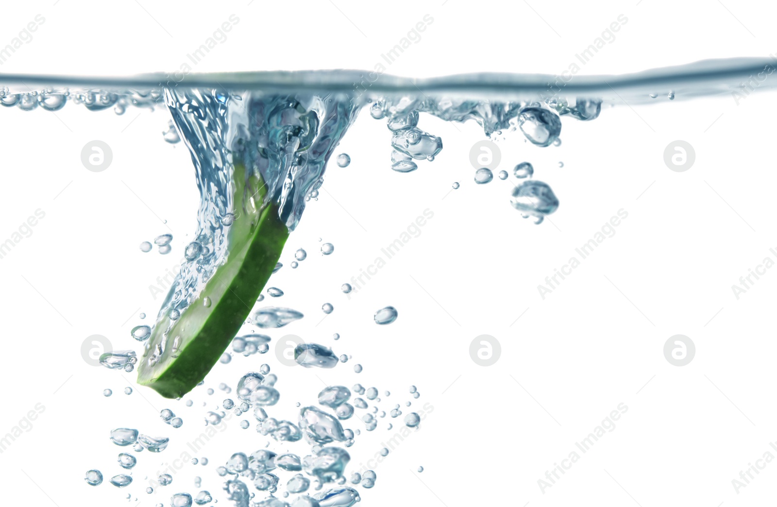 Photo of Slice of fresh cucumber falling into glass with water on white background, closeup