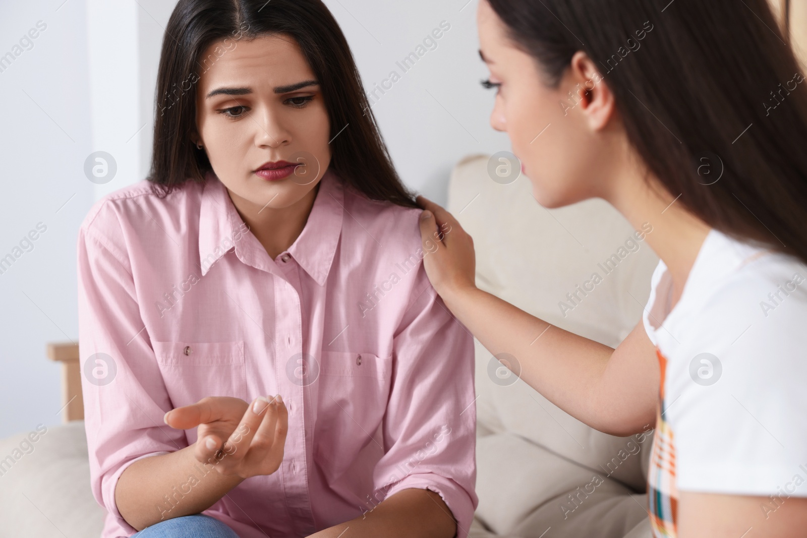 Photo of Professional psychologist working with young woman in office