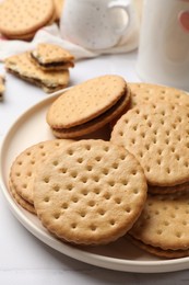 Photo of Tasty sandwich cookies on light table, closeup