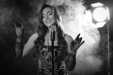 Image of Beautiful singer with microphone, black and white effect