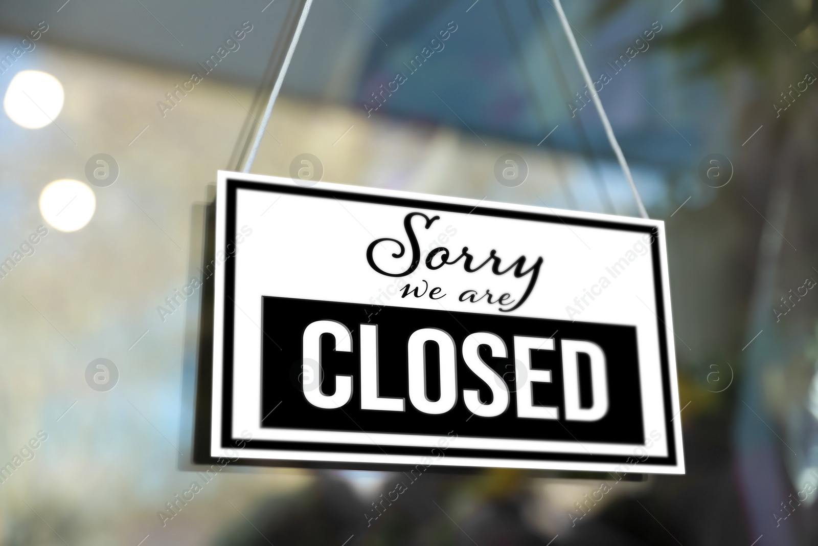 Image of Sorry we are closed sign hanging on glass door