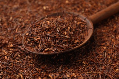 Rooibos tea and wooden spoon, closeup view