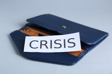 Photo of Purse with word Crisis on white background