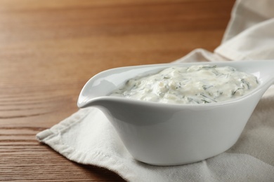 Photo of Cucumber sauce on wooden background. Traditional Tzatziki