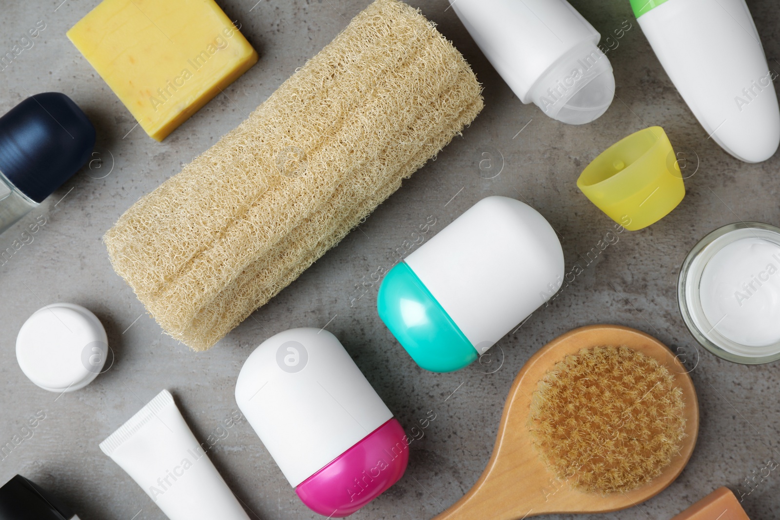 Photo of Flat lay composition with natural deodorants and bath accessories on grey marble table