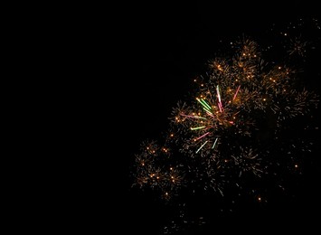 Photo of Beautiful bright fireworks lighting up night sky, space for text