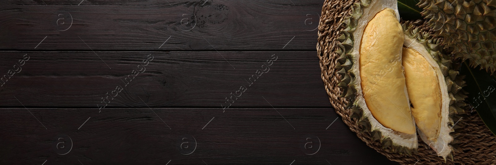 Image of Fresh ripe durians on wooden table, top view with space for text. Banner design