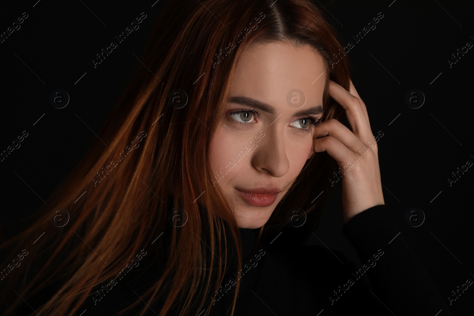 Photo of Evil eye. Young woman with scary eyes on black background