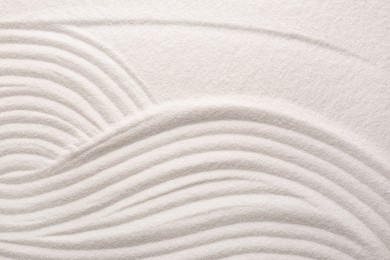 White sand with pattern as background, top view. Concept of zen and harmony