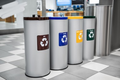 Photo of Different recycling bins for trash in shopping mall